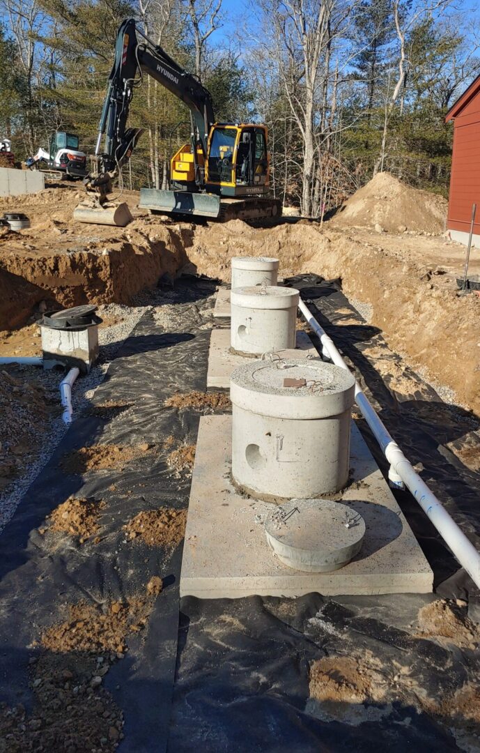 A construction site with cement and pipes.