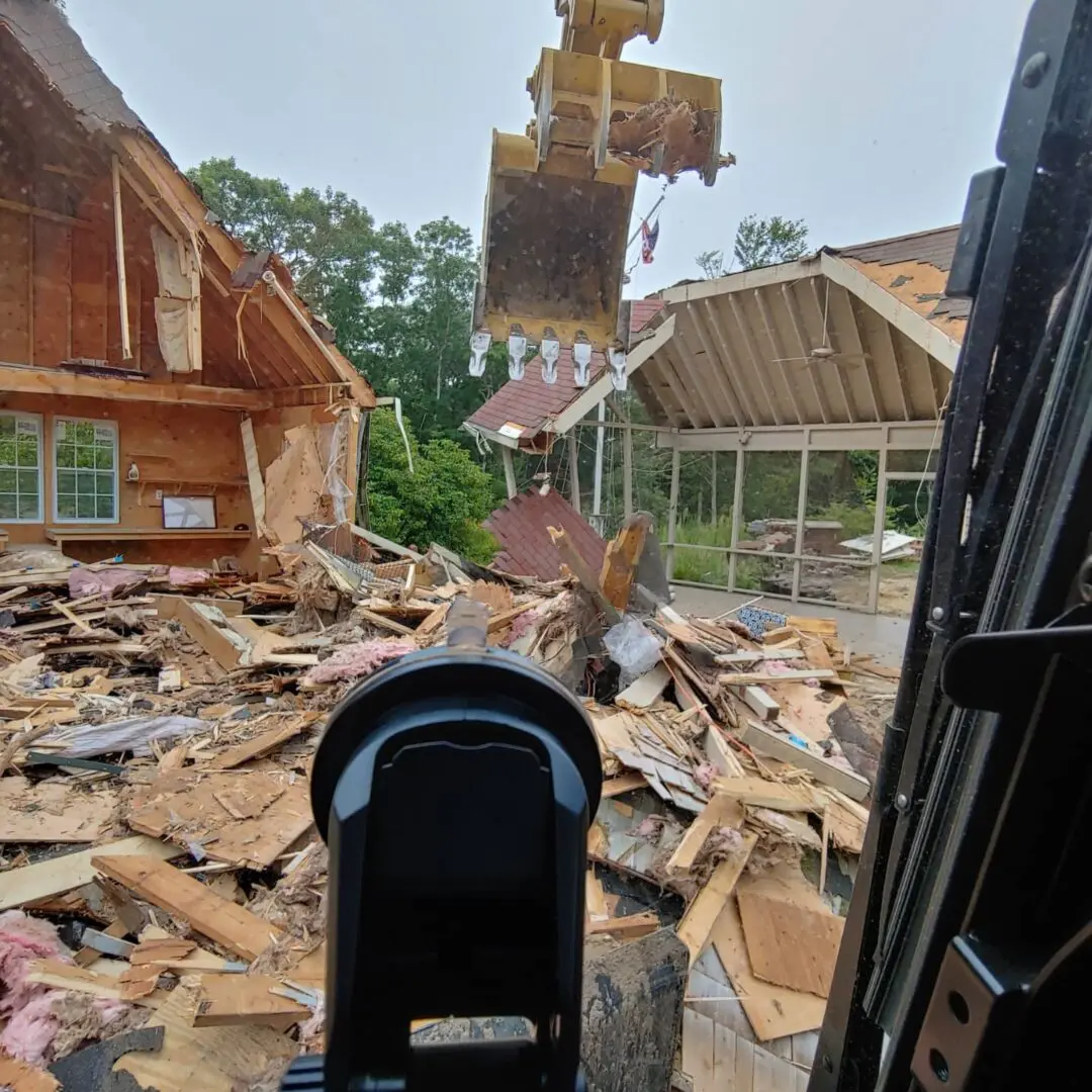 A mailbox sitting in the middle of a pile of rubble.