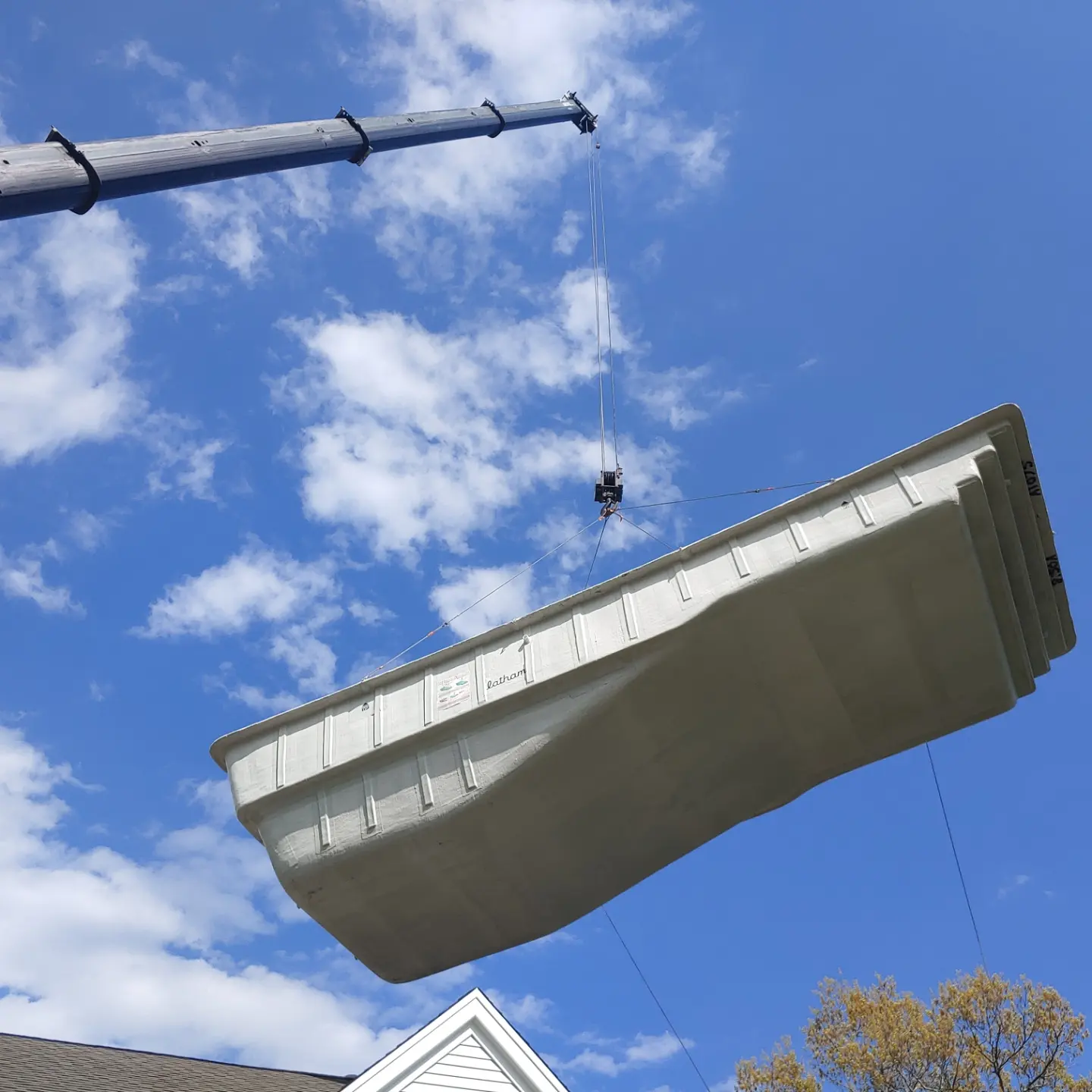 A large piece of metal hanging from the side of a building.