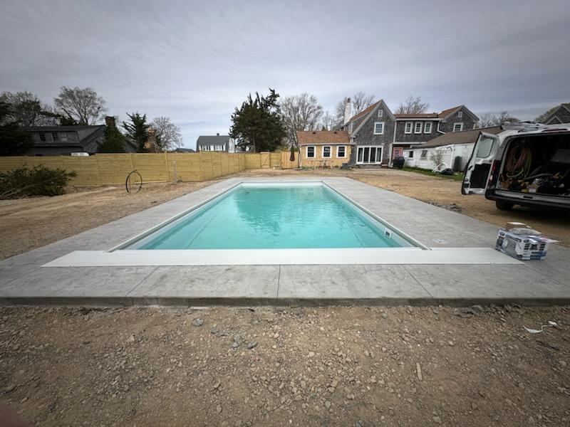 A pool that is in the middle of some dirt.